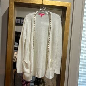 Lilly Pulitzer cream cardigan with gold chain detail.